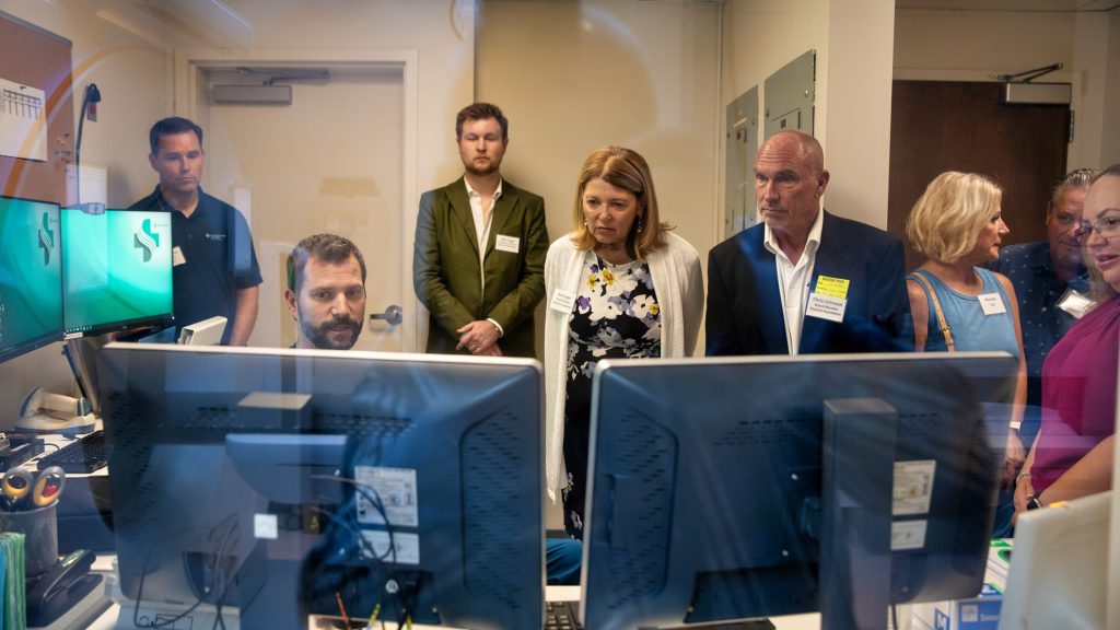 Group of people looking at computer monitors