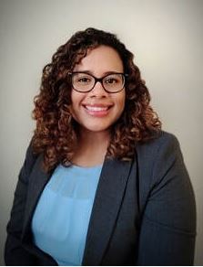 image of a woman with glasses and blue shirt