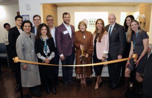 Group of people gathered at a ribbon cutting