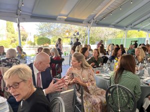 Sutter Health CEO Warner Thomas speaks to a guest at the Mills-Peninsula Hospital Foundation Women’s Health Luncheon & Lecture