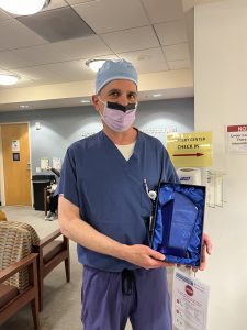 Dr. Fazzolari holding Spirit Award from Operation Access.