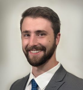 Male resident smiling in suit for headshot