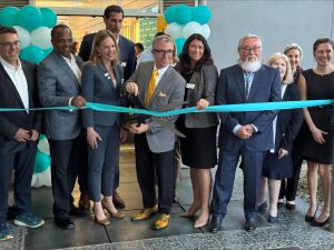 Healthcare executives, government and city officials, gather around the mayor of Morgan Hill to cut the ribbon at the opening of the new care center. 