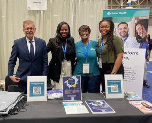 Sutter team members gather for a photo at their AMEC 2024 booth.