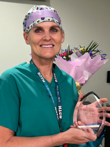 Nurse with flowers and award