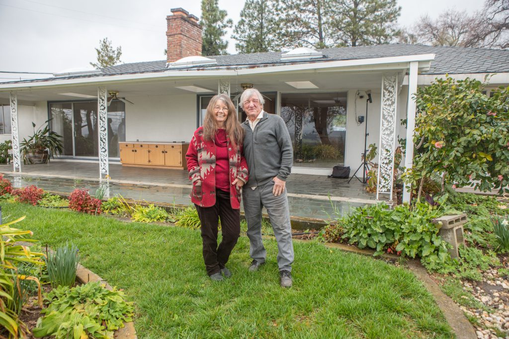 Couple in front of home