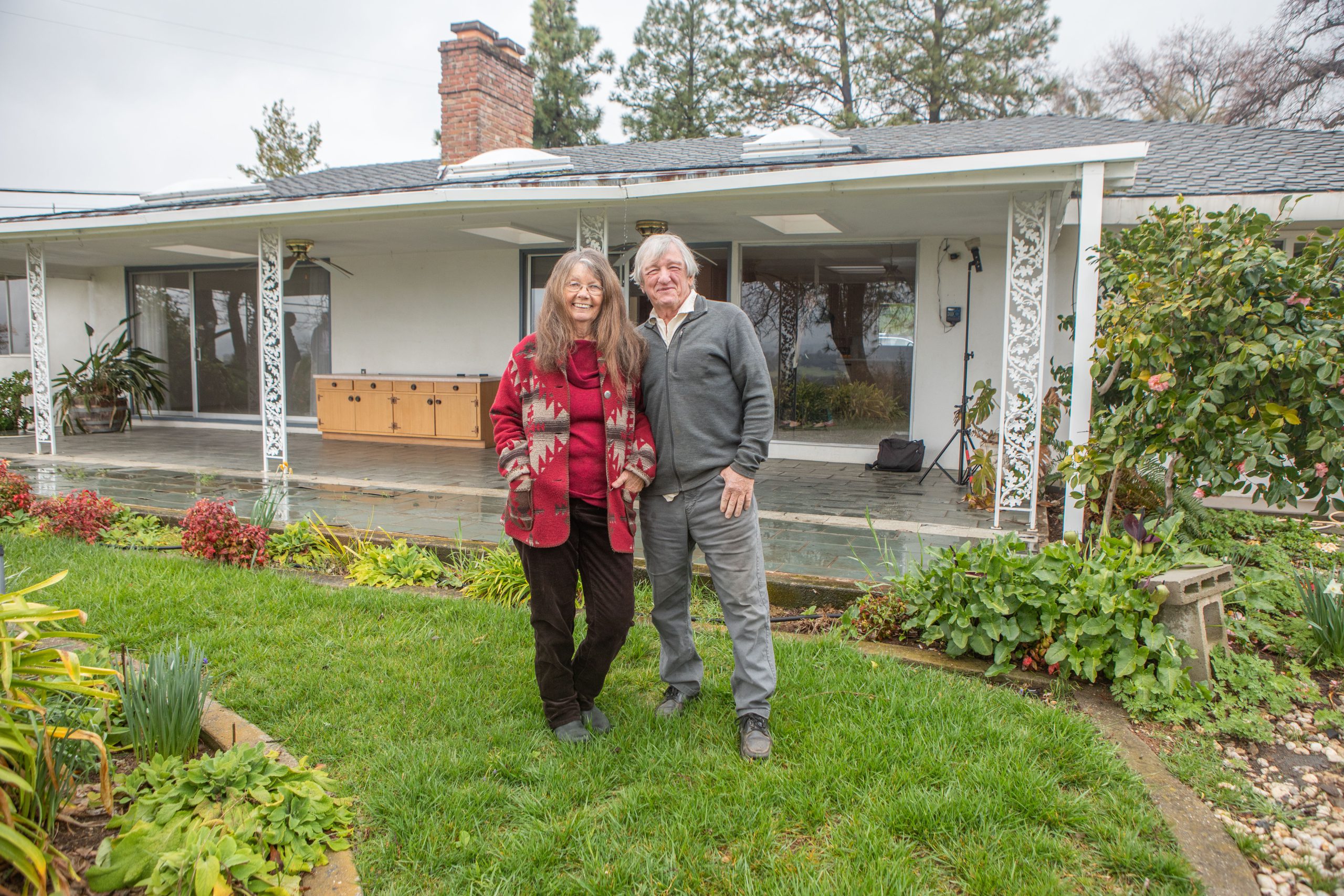 Couple in front of home