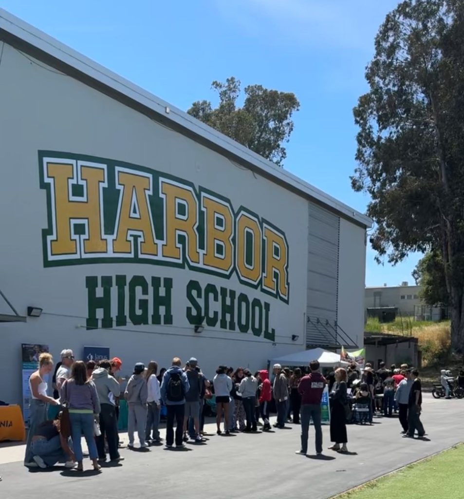 Students and their families line up in front of the gym to receive free physicals.