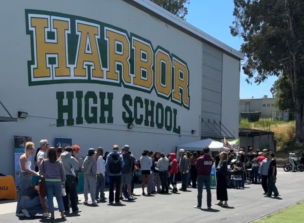 Students and their families line up in front of the gym to receive free physicals.