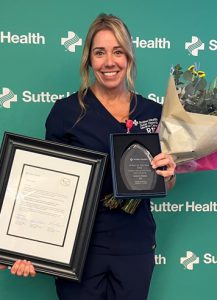 Nurse with awards and flowers