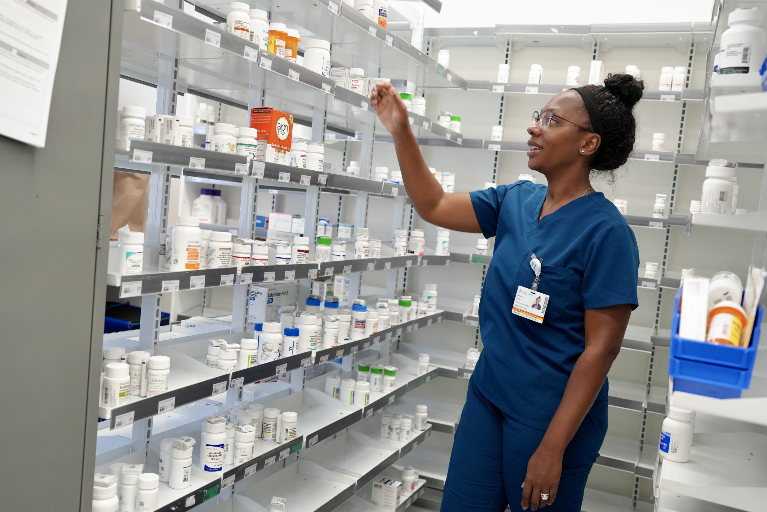a pharmacist searches for a medication