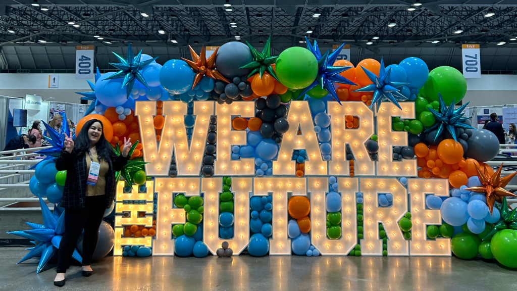 Dr. Bethishou in front of letters spelling We Are The Future at AAFP National Conference