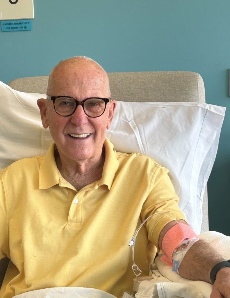 Older man in yellow shirt receives infusion for Alzheimer's