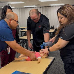 Dr. Bethishou, right, learning CPR at Sutter's Memorial Medical Center
