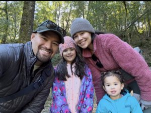 Dr. Alvarez, his wife, and their two kids share a photo from a day in the park.