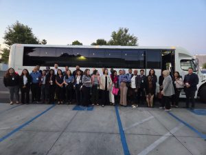 Group of residents standing outside of a bus