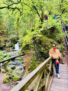 Jennifer stops to smile for the camera before walking across the bridge on her hike.