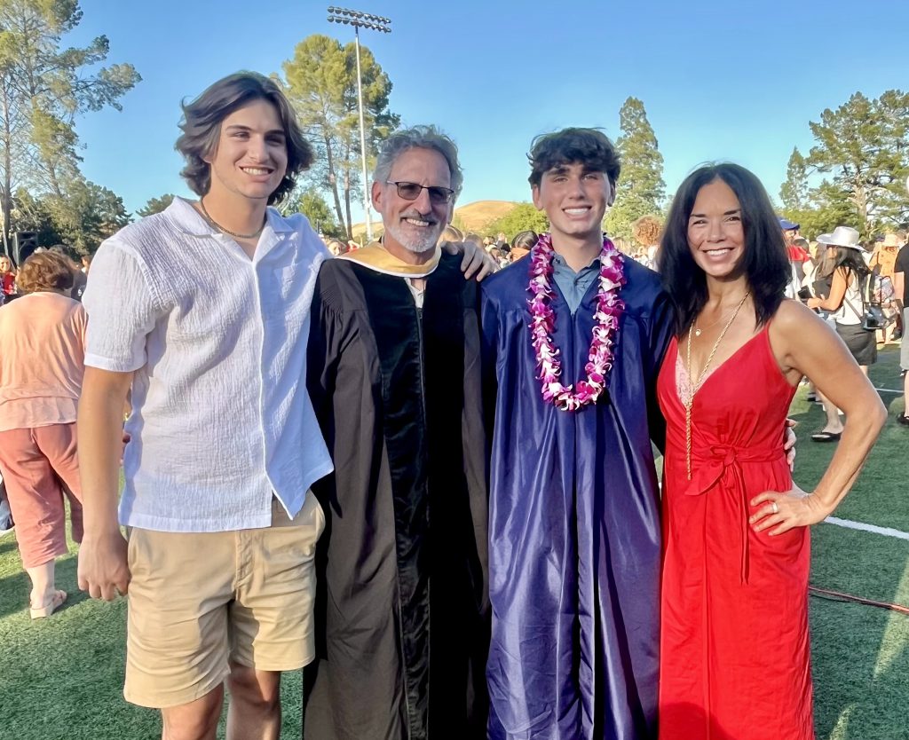 Jennifer and her family pose for a photo at her son's graduation.