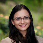 Portrait of female doctor smiling, glasses, long brown hair