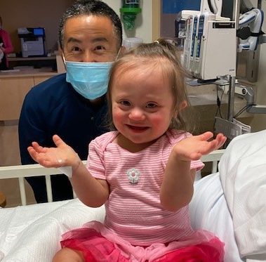 Little girl patient and doctor behind her