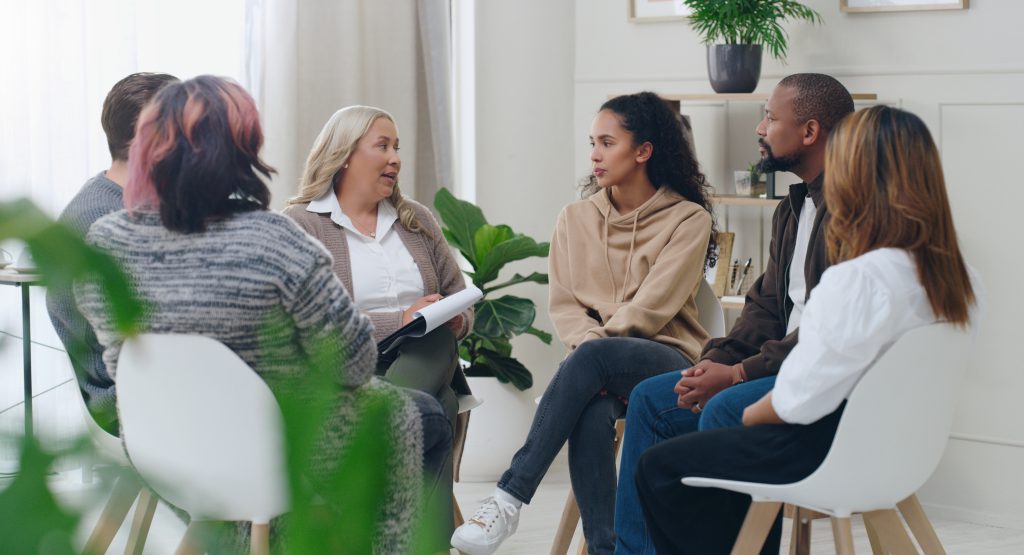 A group gathers for a therapy session
