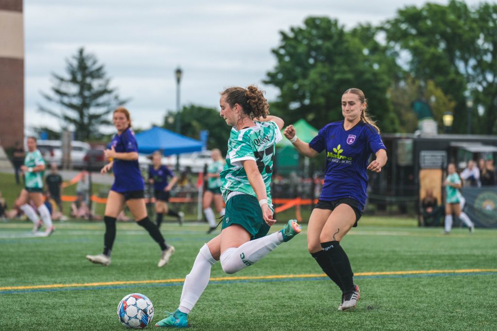 Lexi Quinn kicks the ball during a soccer game.