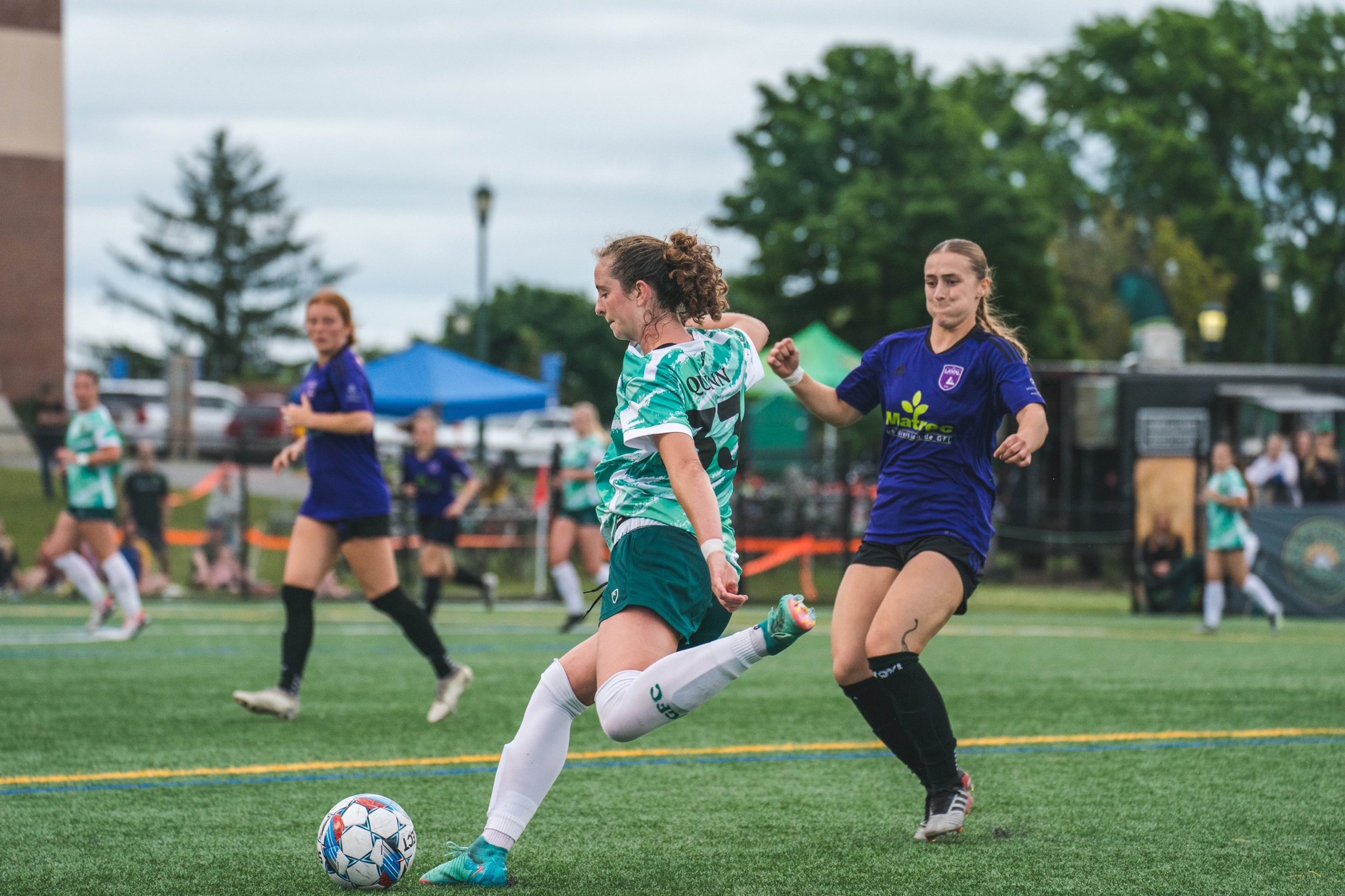 Lexi Quinn kicks the ball during a soccer game.
