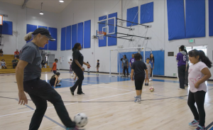 Screenshot from video of volunteers playing soccer at a clinic