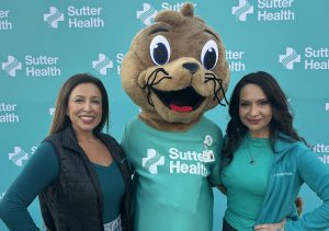 Blanca Martinez (right) was honored at a recent Cal Football game. Pictured with Farah Montalvo (left) and Sutter's mascot, River.
