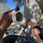 Marcela Tinka kissing a horse on the nose