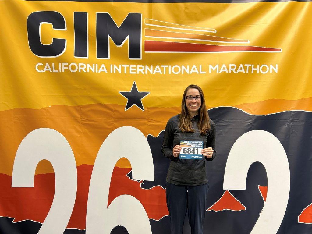 Myriah Surman poses in front of the CIM signage.