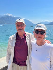 Older couple smiling in front of a lake