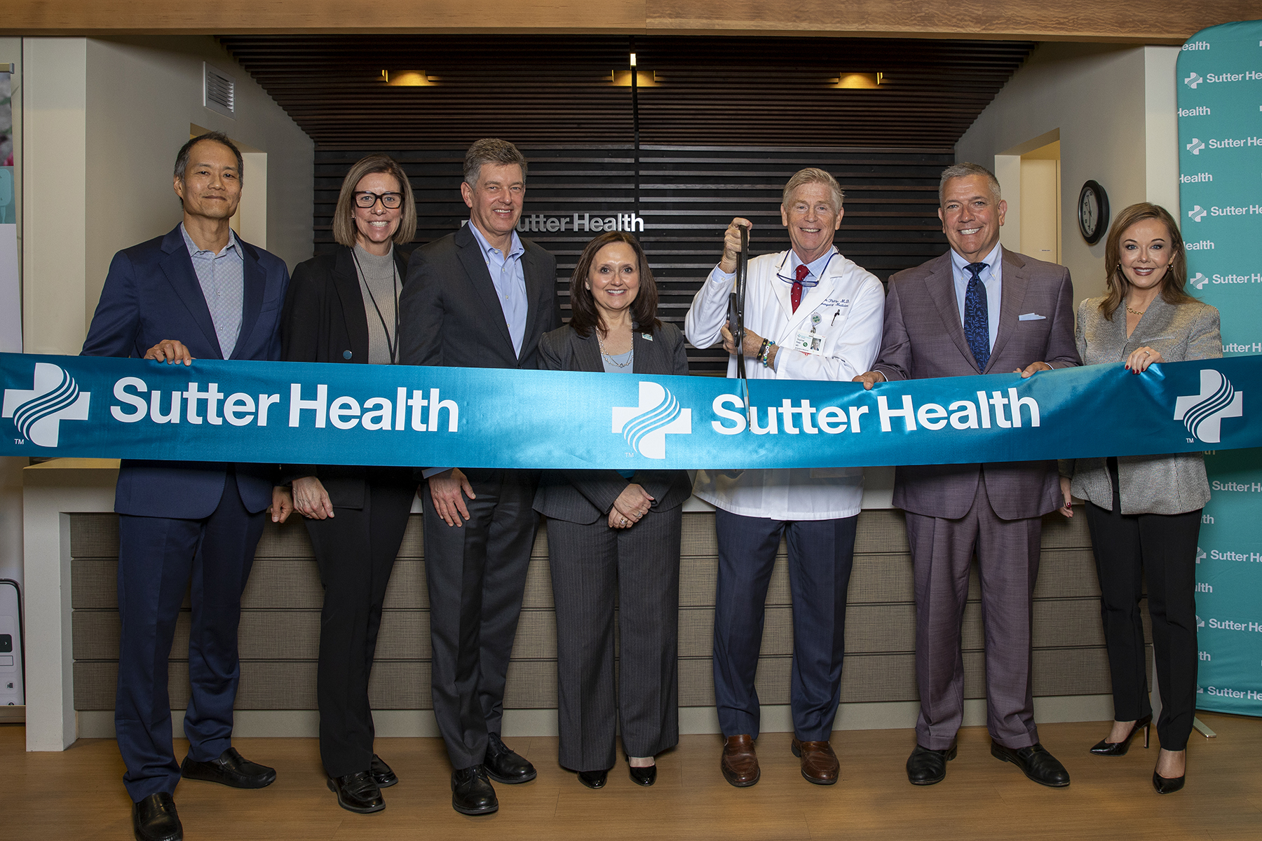 2025_Ribbon Cutting_M6A2613_4x6_300ppi A group of executives cut a ribbon that says Sutter Health