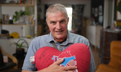 Patient Chris Dowd with heart pillow