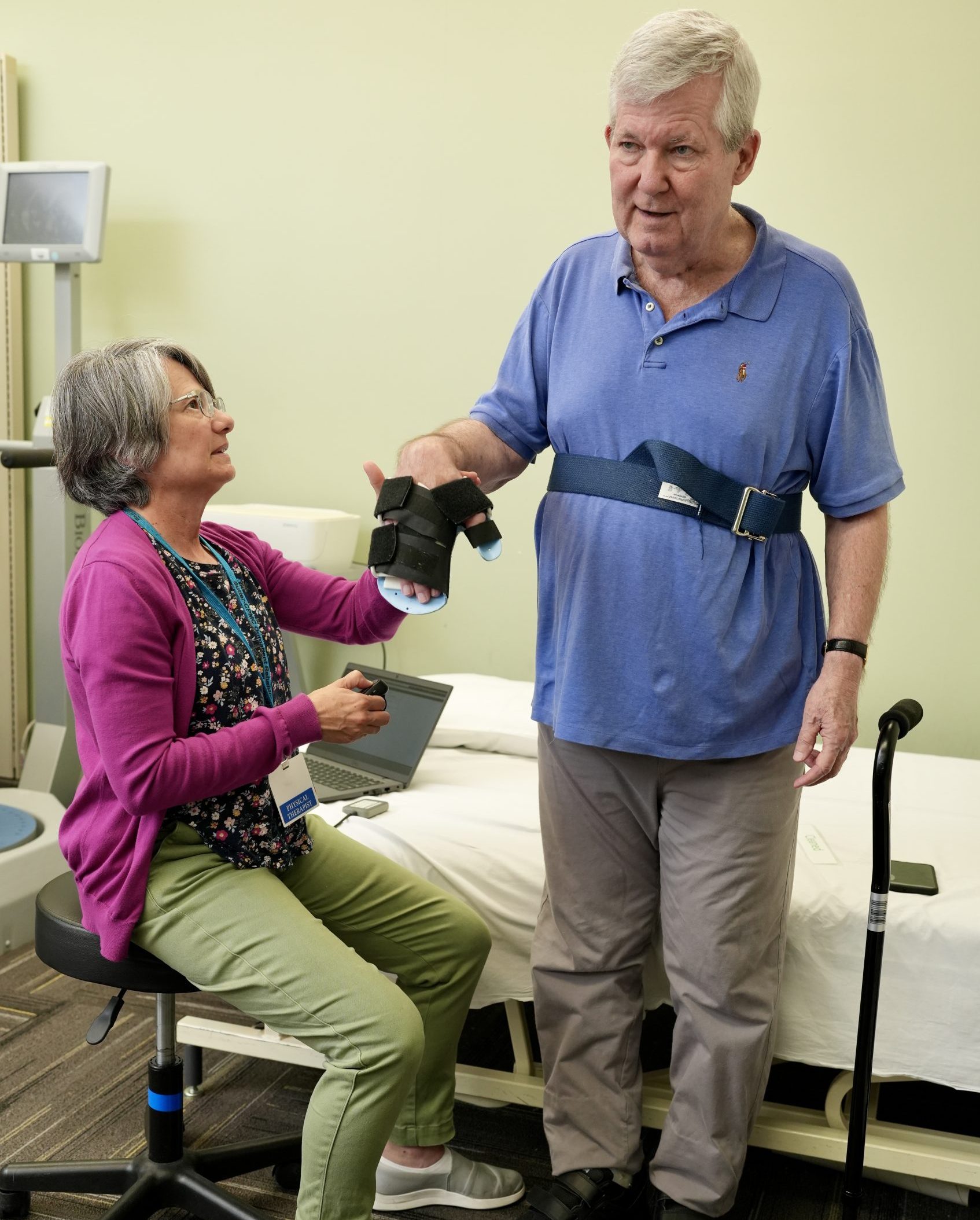 A female physical therapist works with a male patient