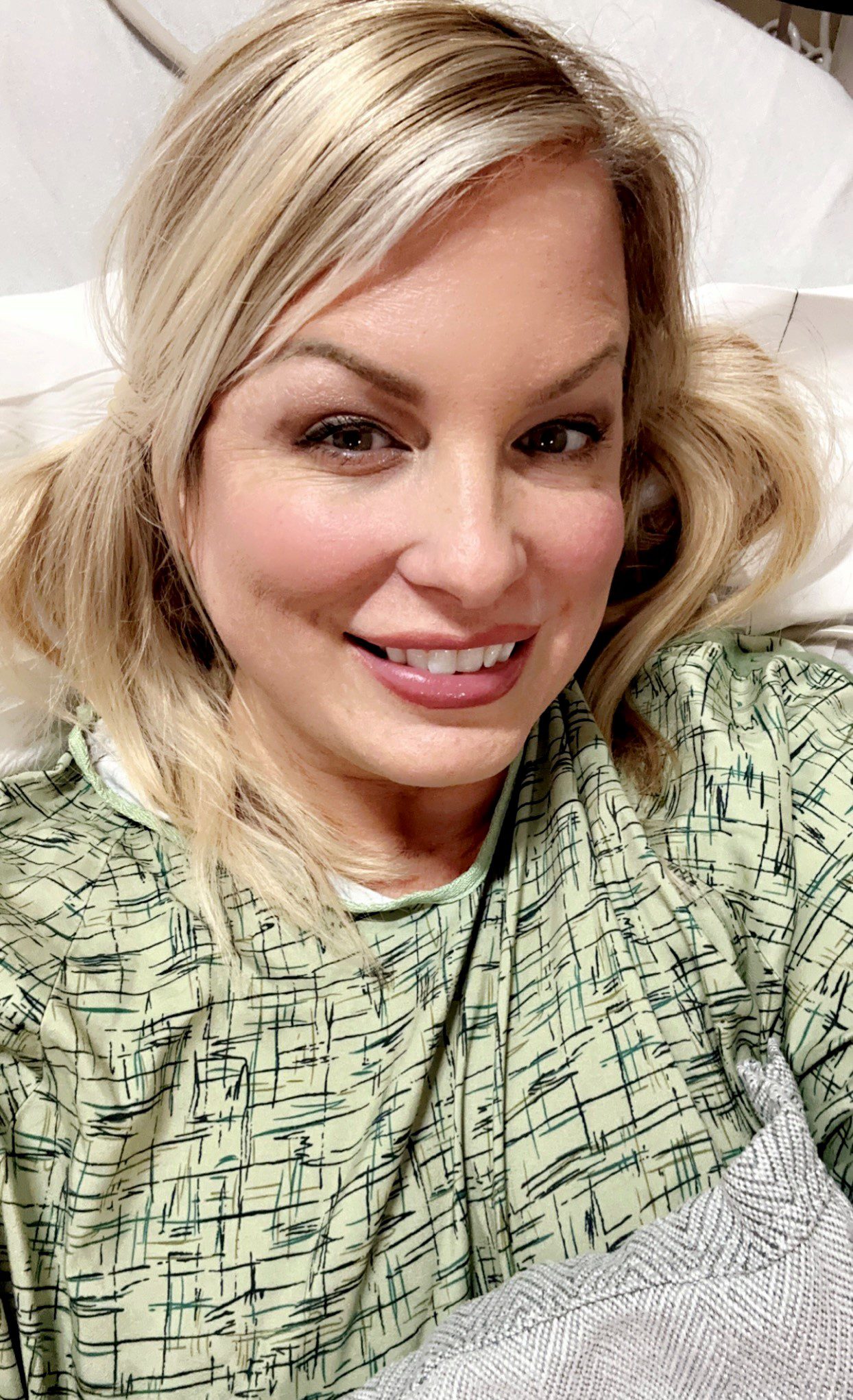 A blonde woman in a hospital gown