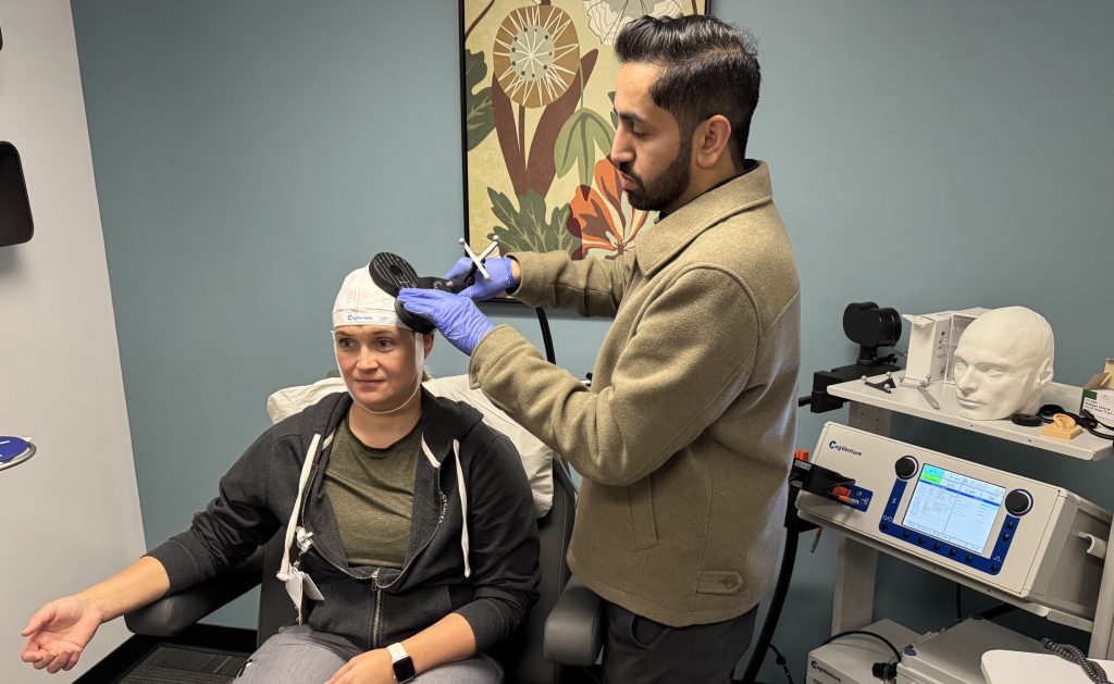 Doctor uses TMS on patient