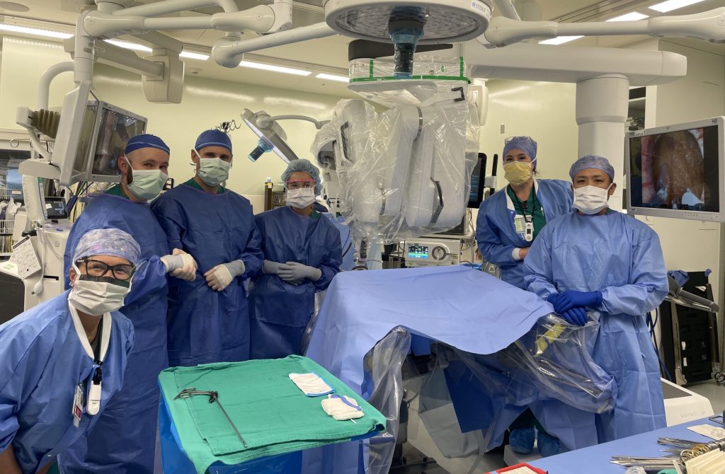 Surgical team stands in scrubs in a hospital operating room