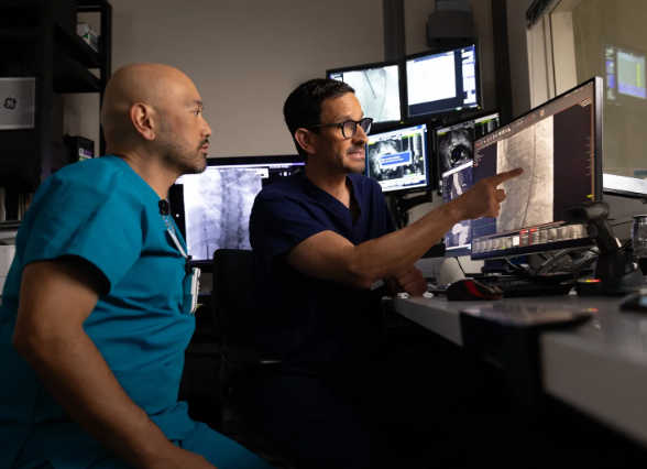 Two clinicians review a medical image