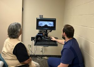 Two healthcare workers demonstrate advanced eyewear goggles that help detect that cause of vertigo and other balance disorders