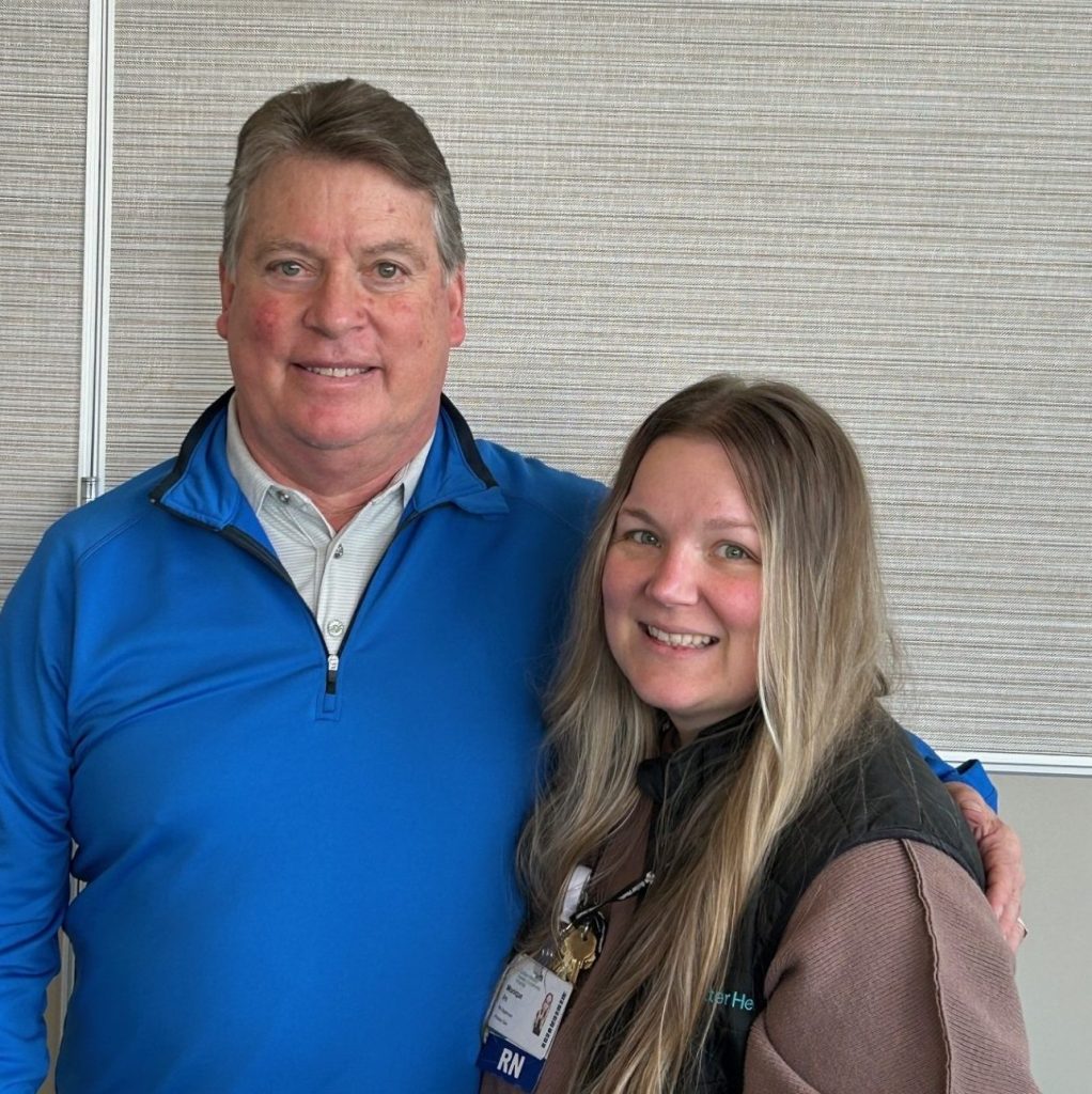 A father and daughter stand next to one another