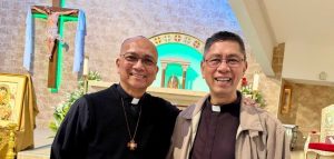 Two priests stand side by side