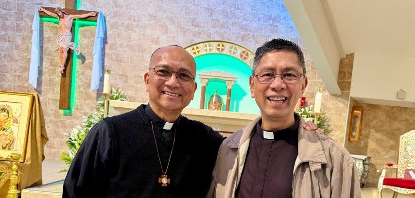 Two priests stand side by side