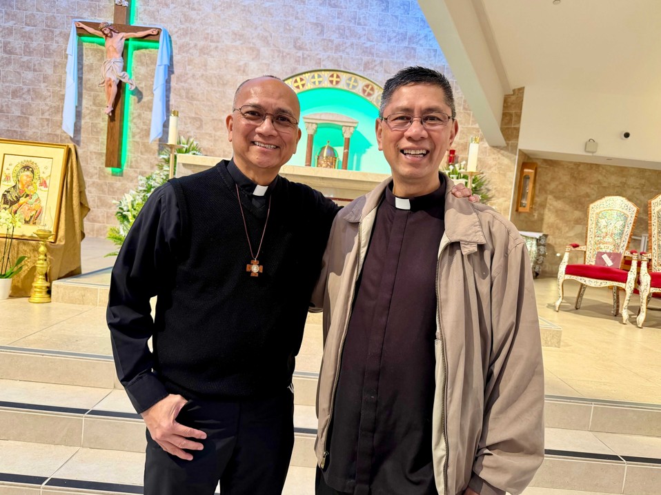 Two priests stand side by side