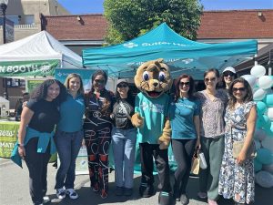 Pictured left to right: Britney Gomes, Michelle Aragon, Dr. Brenda Chuksorji, Dr. Hardeep Saini, Sutter Health mascot River, Sandra Zarich, N.P., Dr. Jessica Tsai, Dr. Susan Adham, and Dr. Fatima Syed at the Brentwood farmer’s market.