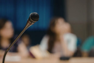 blurred background, microphone in focus, physician workforce