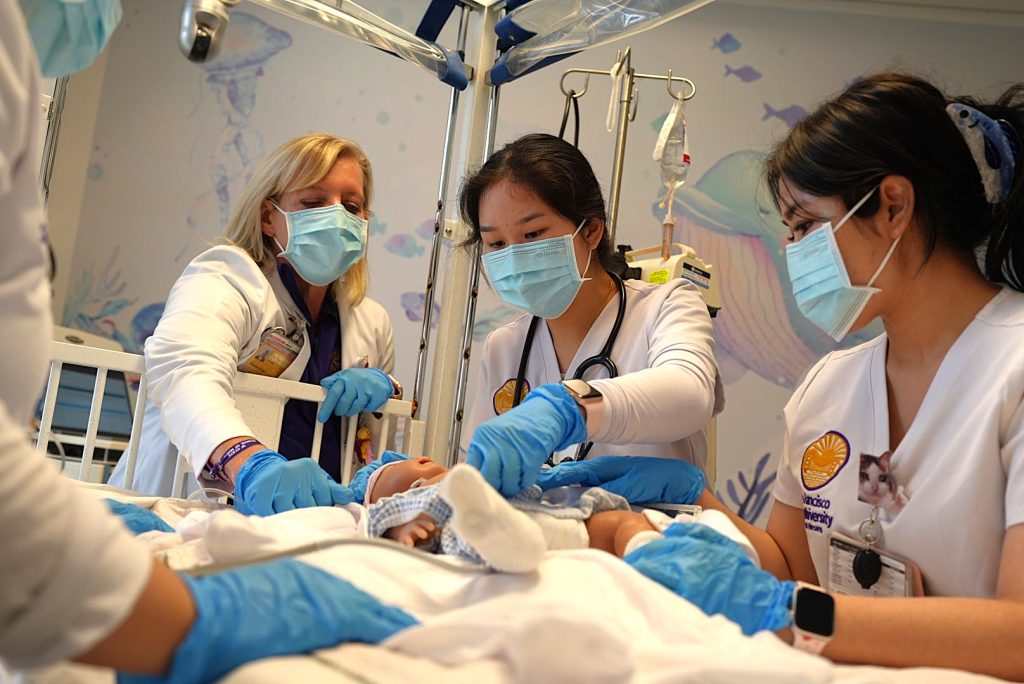 Nursing students and instructor participate in a pediatric nursing simulation