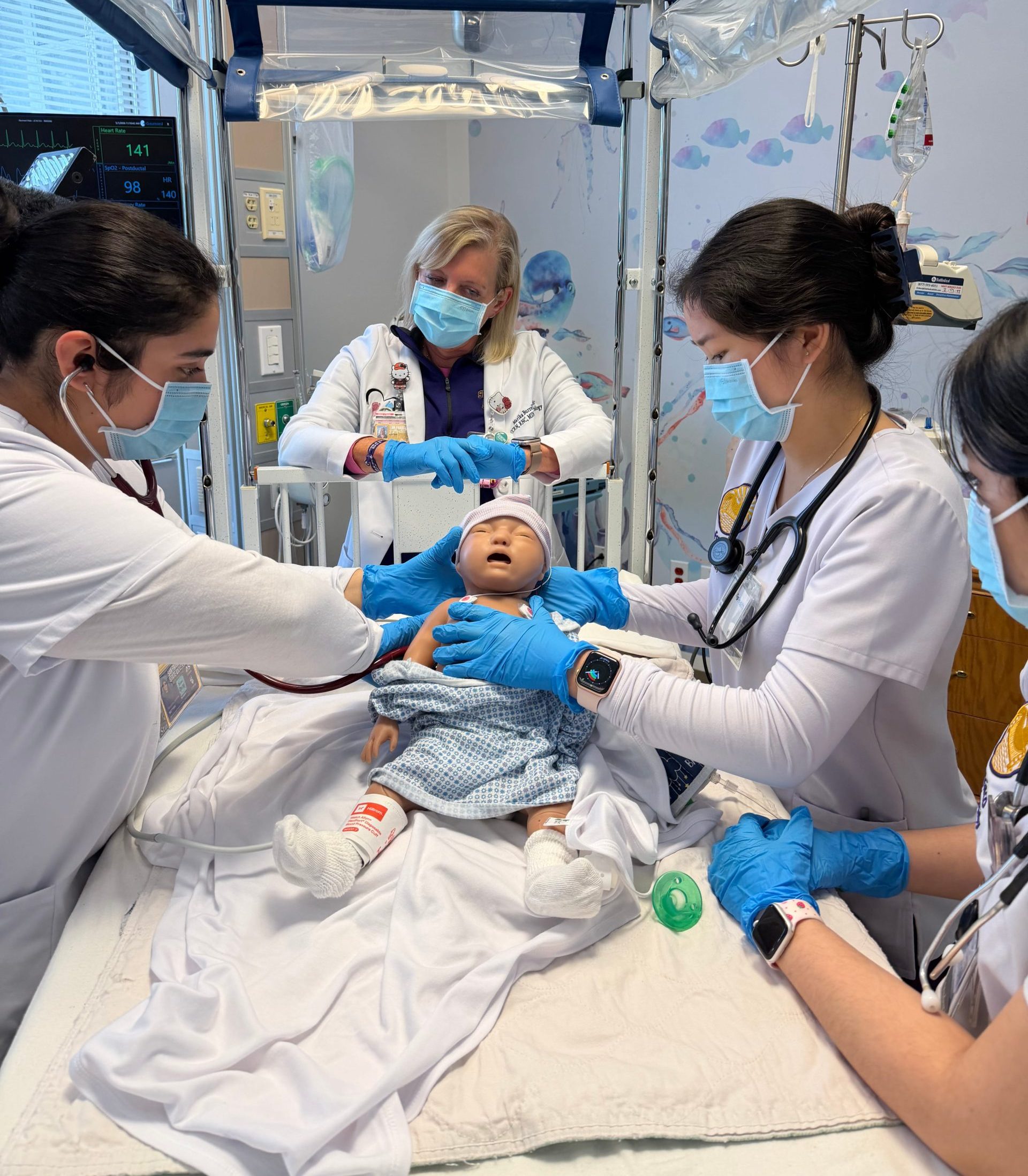 Nursing students are guided by a clinical instructor during a pediatric code