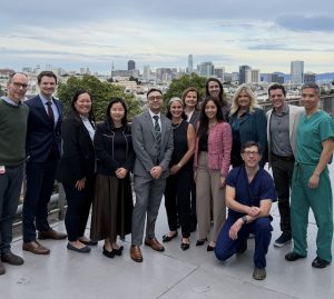 Group of people stand with the San Francisco city skyline in the background