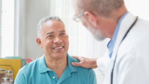 Doctor talking to patient in office